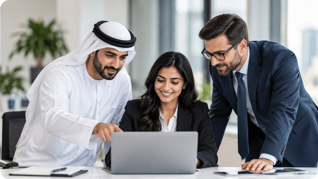 Delta HRMS team reviewing HR and payroll software on a laptop in Dubai